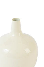 Cremeweiße, glänzende Vase mit bauchigem Korpus und schmalem Hals, in frontaler Nahaufnahme leicht von oben vor weißem Hintergrund