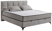 Graues Boxbett mit gestepptem Kopfteil und zwei Kissen, seitliche Perspektive