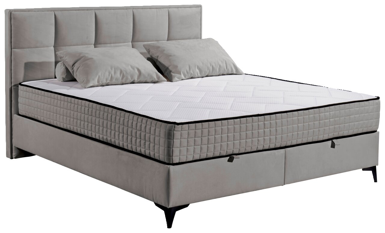 Graues Boxbett mit gestepptem Kopfteil und zwei Kissen, seitliche Perspektive