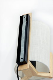 Close-up van een moderne wandlamp met houten en stoffen elementen, zijaanzicht