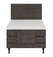 Donkergrijs gestoffeerd eenpersoons boxspringbed met hoog hoofdbord, wit matras en zwarte poten, recht van voren gezien