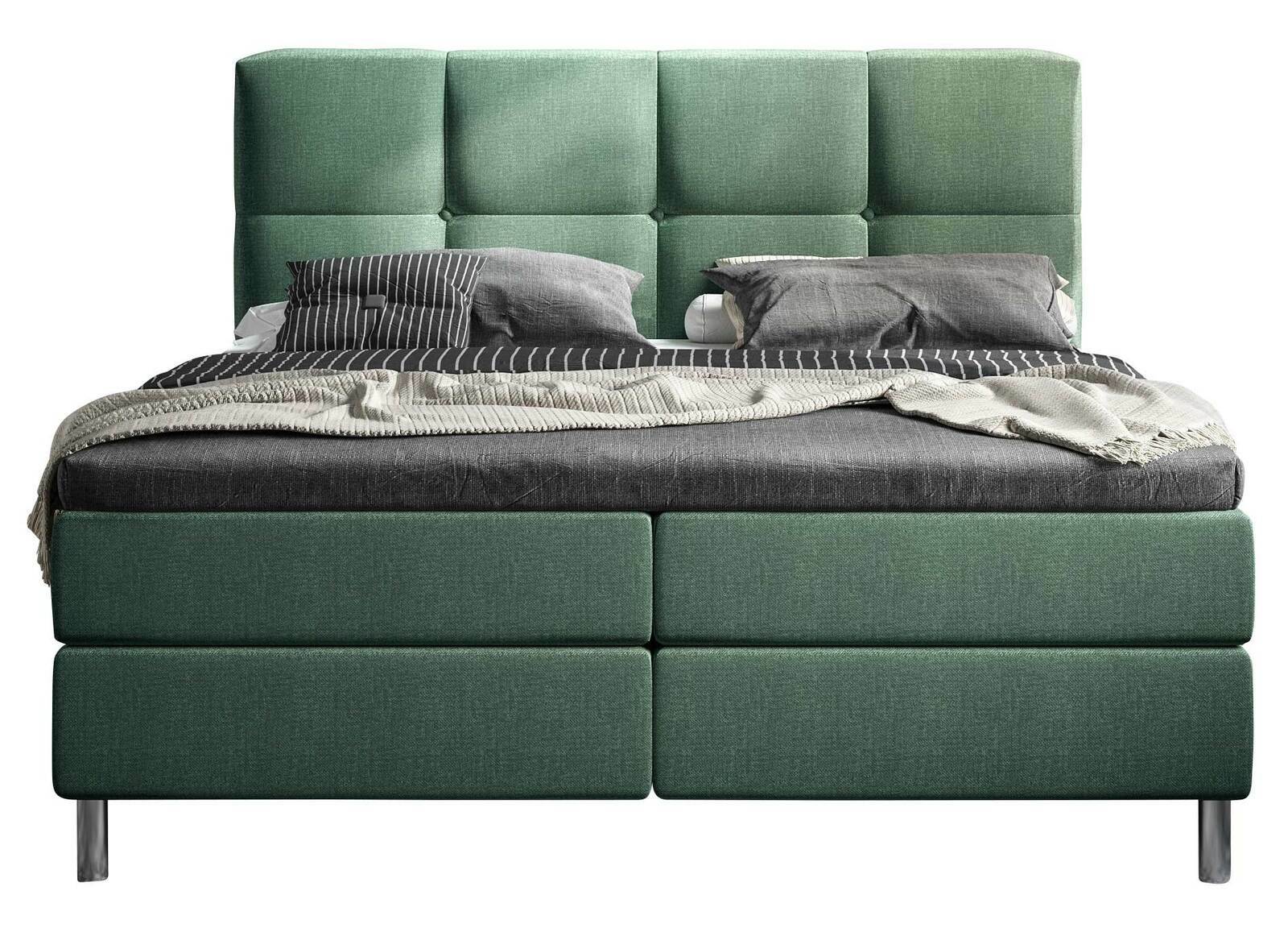 Grünes Boxbett mit gestepptem Kopfteil, frontal fotografiert, mit grauer Bettwäsche und Kissen.