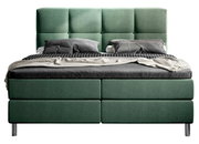 Grünes Boxbett mit gestepptem Kopfteil, frontal fotografiert, mit grauer Bettwäsche und Kissen.