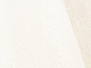 Nahaufnahme eines weichen, cremefarbenen Teppichs mit flauschiger Textur.