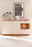 Modernes Sideboard MANITOBA in heller Holzoptik mit dekorativen Vasen und Pflanzen, frontal fotografiert.