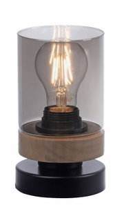 Moderne Tischleuchte mit zylindrischem Rauchglas-Schirm, sichtbarer LED-Filamentlampe und Holzsockel auf schwarzem Fuß, frontale Ansicht