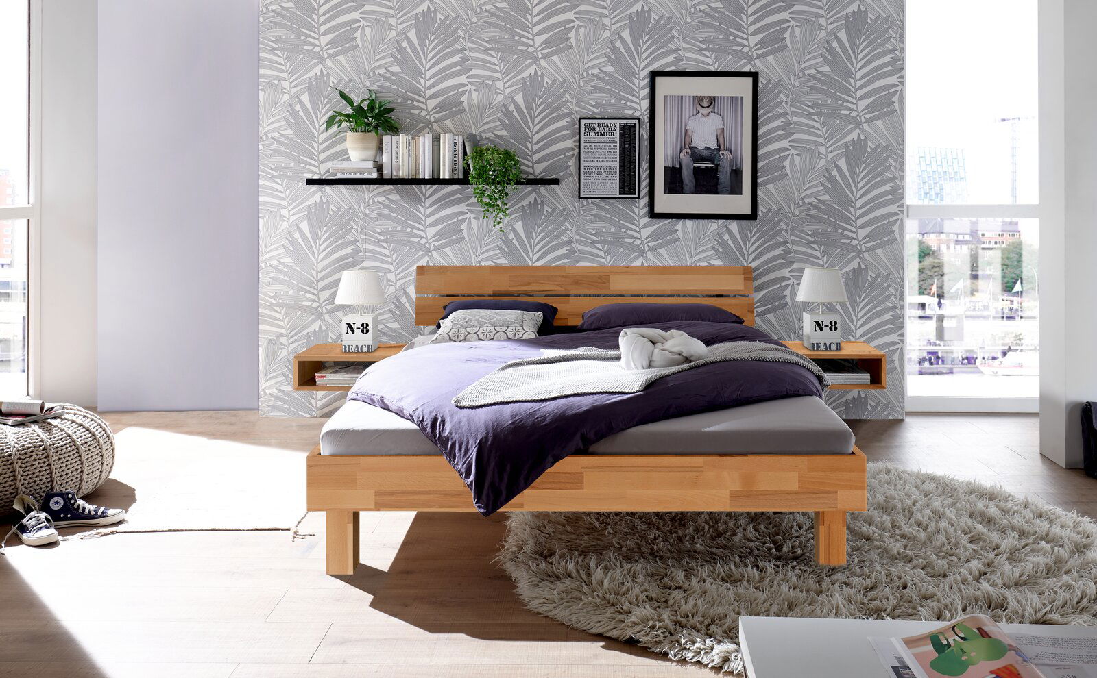 Holz- und Metallkopfteil in einem modernen Schlafzimmer, frontal betrachtet, mit dekorativen Elementen und einem großen Fenster im Hintergrund.