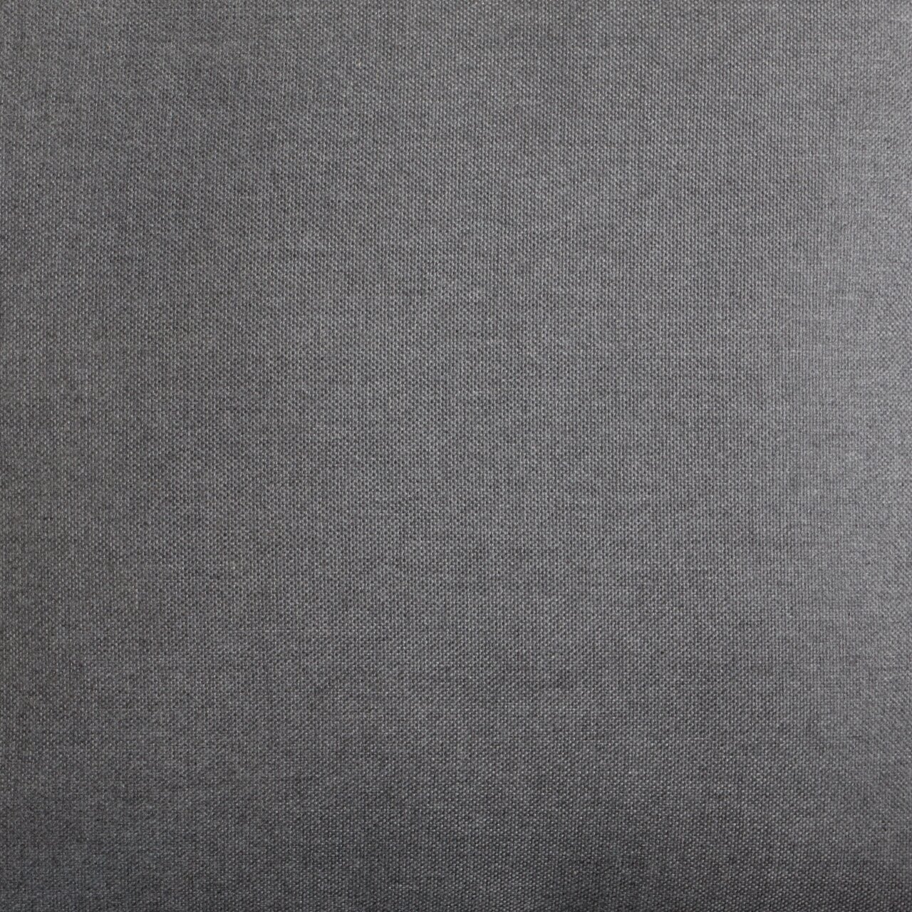 Nahaufnahme eines grauen Stoffes, vermutlich Polsterung eines Lounge-Sessels, aus der Vogelperspektive.