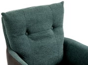 Close-up van een fauteuil met groene stoffen bekleding en knoopdetails, gezien vanaf de voorkant.