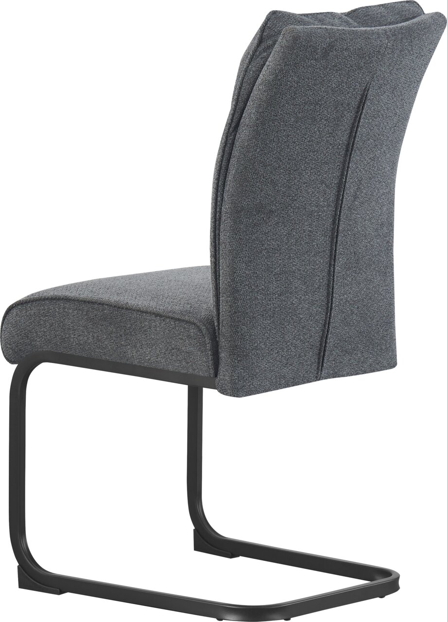 Gepolsterter Freischwinger-Stuhl mit dunkelgrauem Stoffbezug und schwarzem Metallgestell, Seitenansicht schräg von hinten