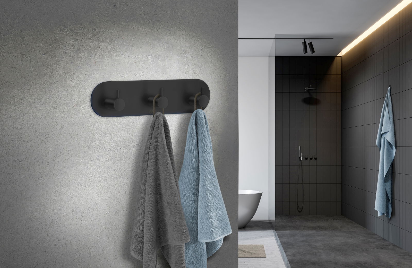 Dreierhaken aus schwarzem Edelstahl an einer Badezimmerwand, frontal betrachtet, mit zwei aufgehängten Handtüchern in Grau und Blau.