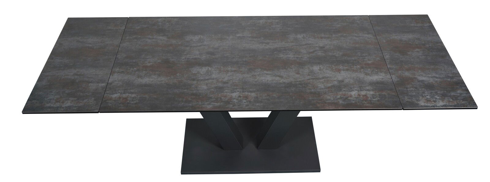 Moderner Esstisch mit dunkler, steinartiger Tischplatte und V-förmigem Fuß, Ansicht von oben.