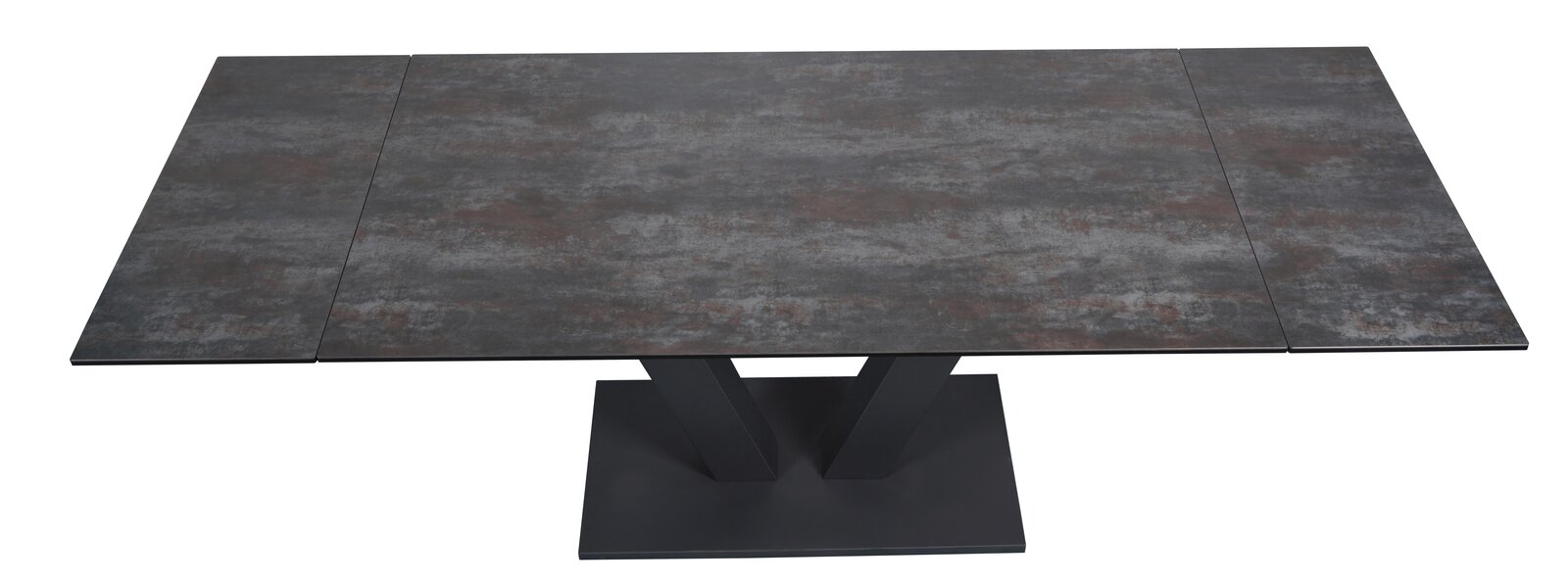 Moderner Esstisch mit dunkler, steinartiger Tischplatte und V-förmigem Fuß, Ansicht von oben.