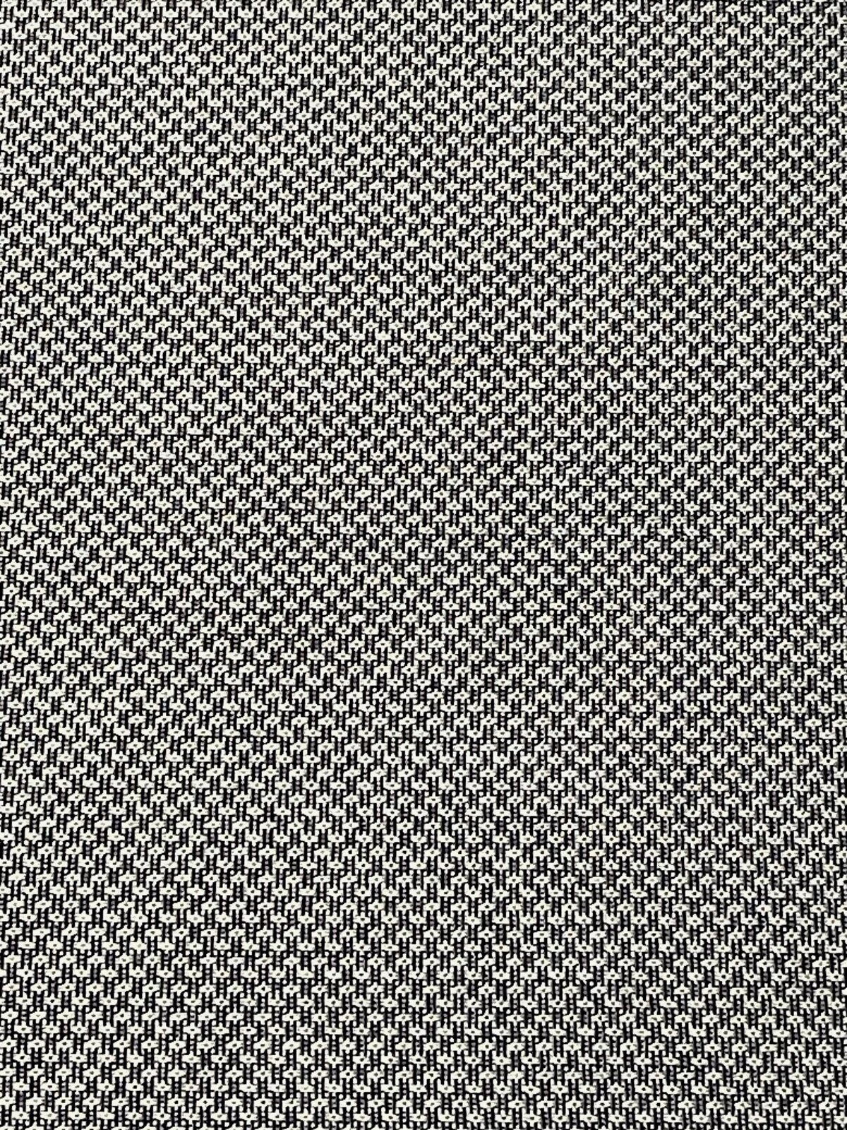 Nahaufnahme eines schwarz-weiß gemusterten Stoffes, der für eine Niederlehnerauflage verwendet wird.