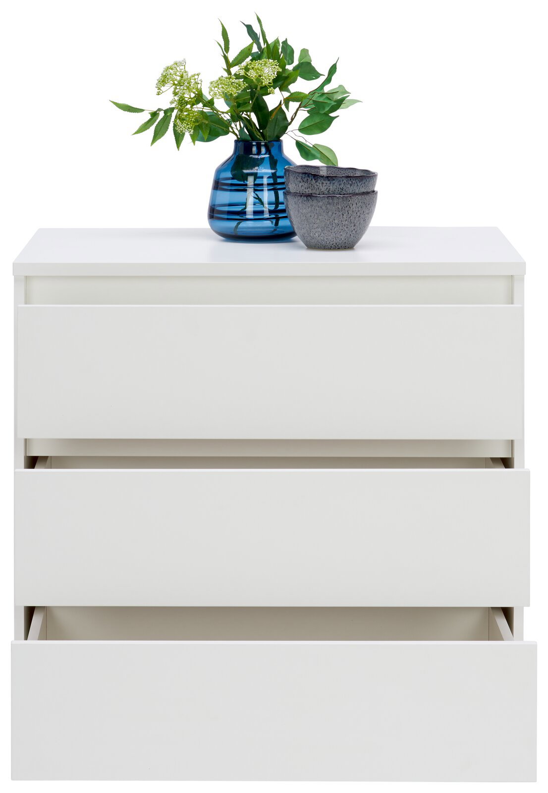 Weiße Kommode mit drei Schubladen, teilweise geöffnet, mit blauer Vase und grünen Pflanzen darauf, Frontalansicht