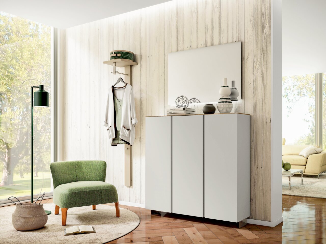 Moderner Eingangsbereich mit Garderobenset, bestehend aus einem weißen Hängeschrank und einem Spiegel, im Vordergrund ein grüner Sessel. Perspektive von schräg vorne.