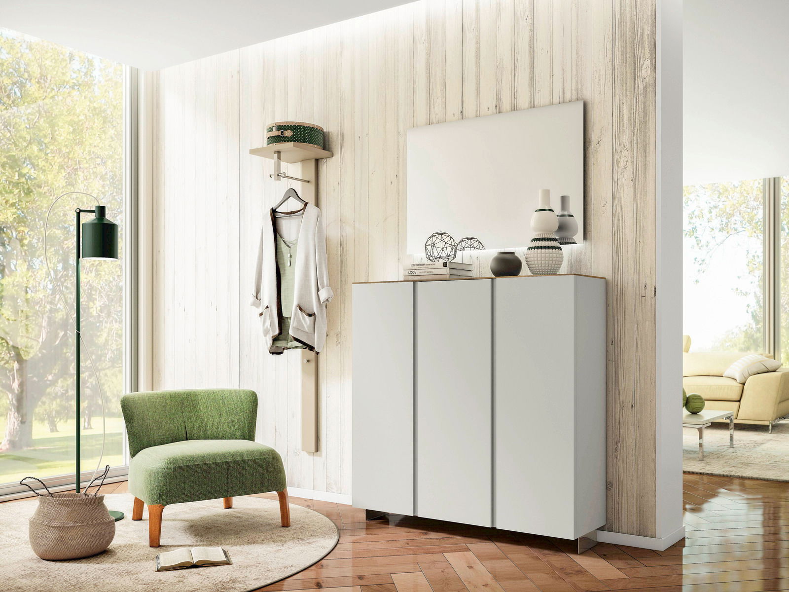Moderano XL-Hängeschuhschrank LECCO Moderner Eingangsbereich mit Garderobenset, bestehend aus einem weißen Hängeschrank und einem Spiegel, im Vordergrund ein grüner Sessel. Perspektive von schräg vorne.