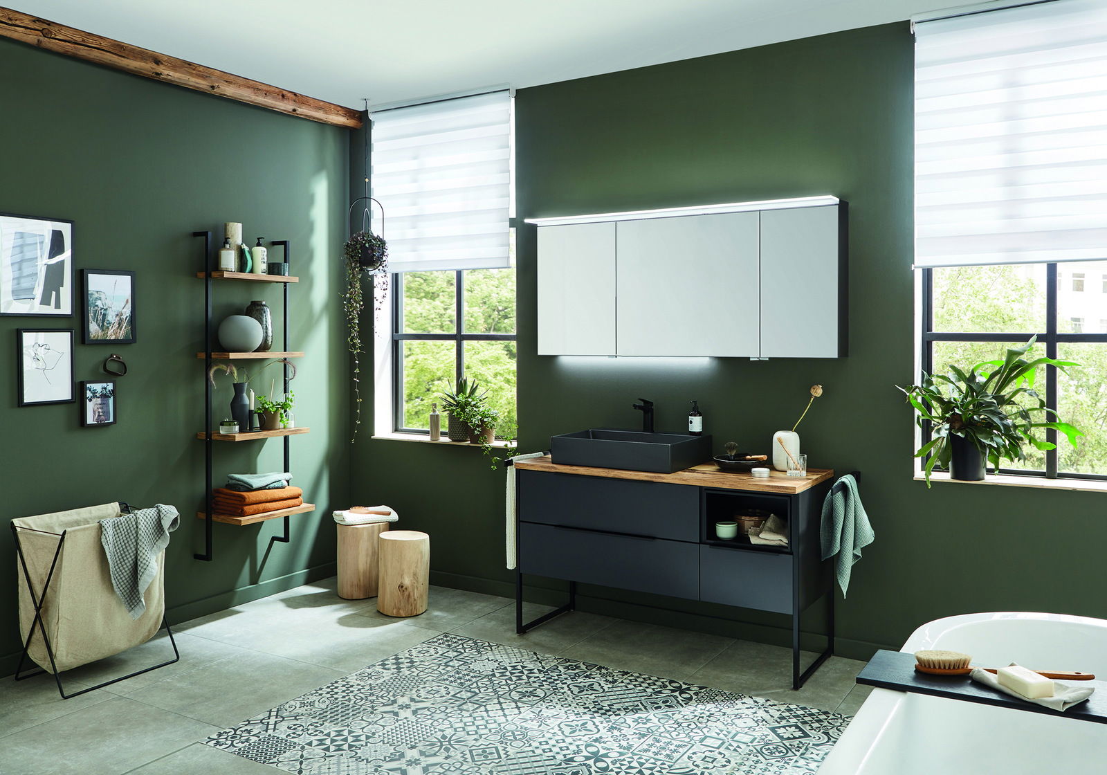 Moderne Badkombination in einem stilvollen Badezimmer mit grünen Wänden, Holzregalen und großen Fenstern, seitliche Perspektive.