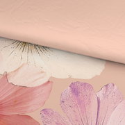 Nahaufnahme einer Wende-Bettwäsche mit floralen Mustern in Rosa- und Lilatönen auf einer Seite und einfarbigem Rosa auf der anderen Seite.