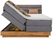 Seitenansicht eines Boxspringbetts mit hochgeklappter Matratze und Stauraum darunter, Modell MARISSA.