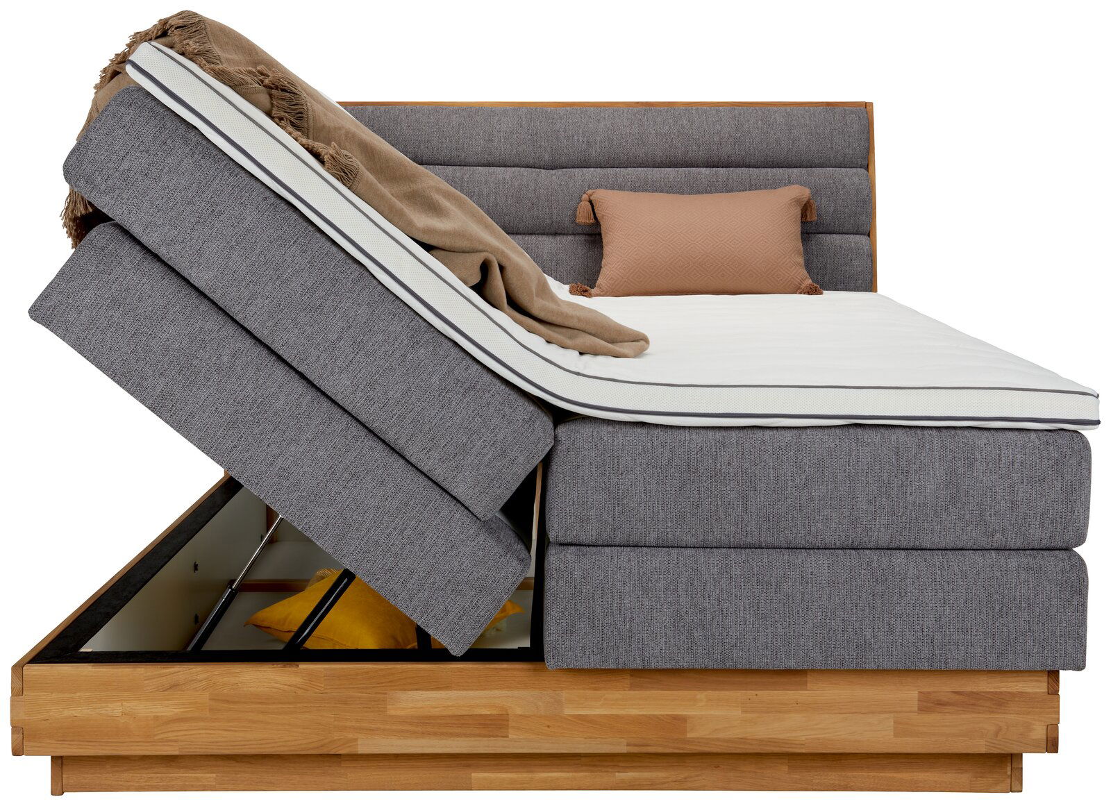 Seitenansicht eines Boxspringbetts mit hochgeklappter Matratze und Stauraum darunter, Modell MARISSA.
