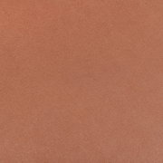 Nahaufnahme einer orangefarbenen, strukturierten Oberfläche eines Stuhlsitzes.