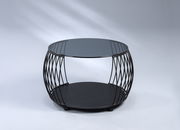 Moderner Couchtisch mit rundem Glasplatte und schwarzem Metallgestell, seitliche Perspektive