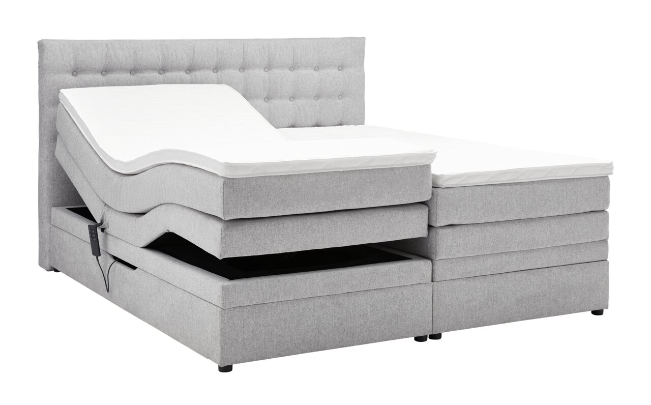 Graues Boxspringbett mit verstellbarem Kopfteil, seitliche Perspektive