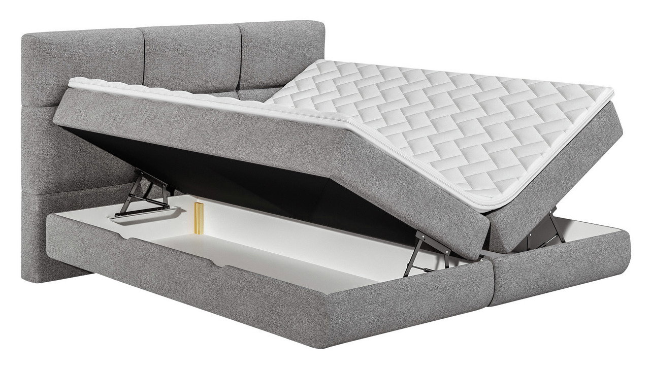 Graues Boxspringbett mit geöffnetem Bettkasten, seitliche Perspektive