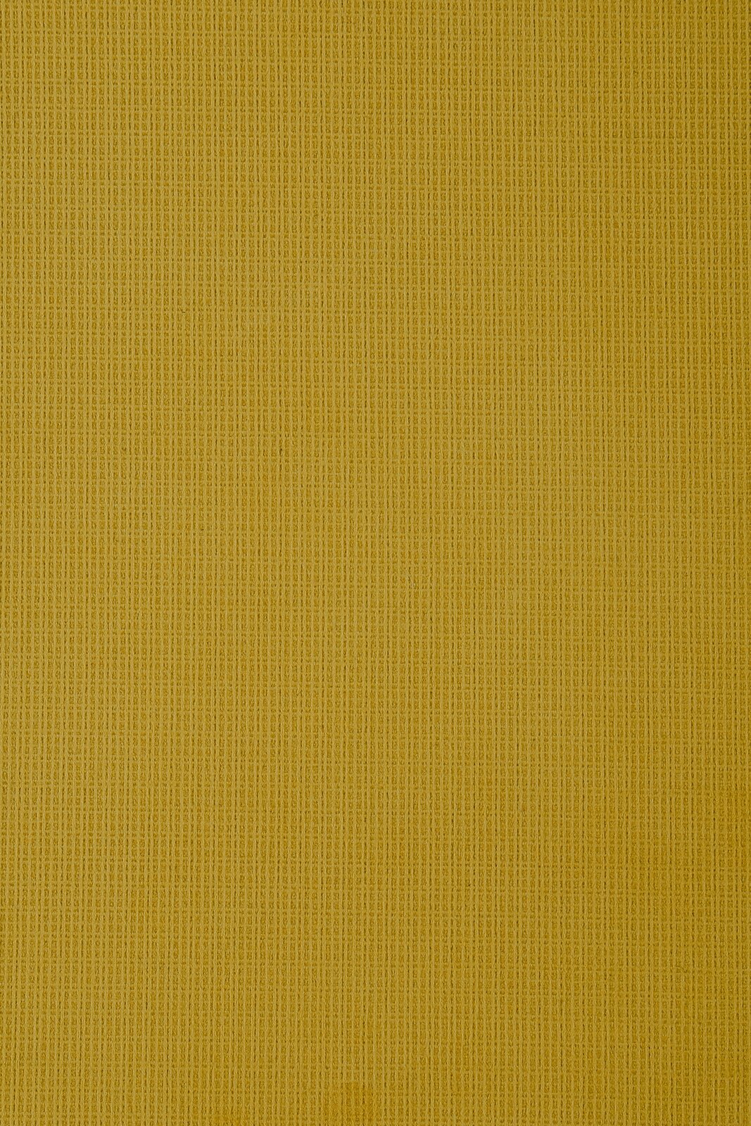 Nahaufnahme eines gelben Stoffes mit feiner Textur, von oben betrachtet.