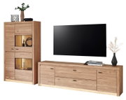 Wohnwand-Set aus hellem Massivholz mit Vitrine mit Beleuchtung, Lowboard mit Schubladen und aufgehängtem Flachbild-TV, frontal in leichter Schrägansicht von vorn auf weißem Hintergrund