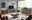 Hom´in Sideboard MAGOLO Modernes Wohnzimmer mit einem eleganten Sideboard in dunklem Grau und Holzoptik, frontal betrachtet. Das Sideboard bietet viel Stauraum und ist Teil einer stilvollen Einrichtung mit einem großen Fenster im Hintergrund.