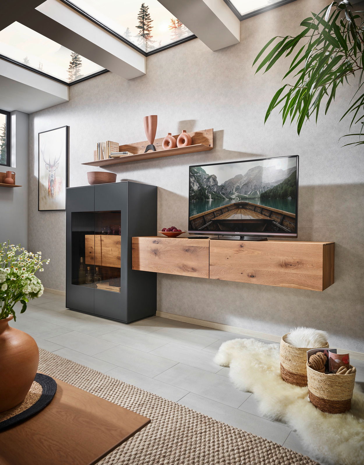 Modernes Wohnzimmer mit Wandpaneel in Holzoptik, hängendem Regal mit Dekorationen und Flachbildfernseher. Perspektive von schräg vorne.