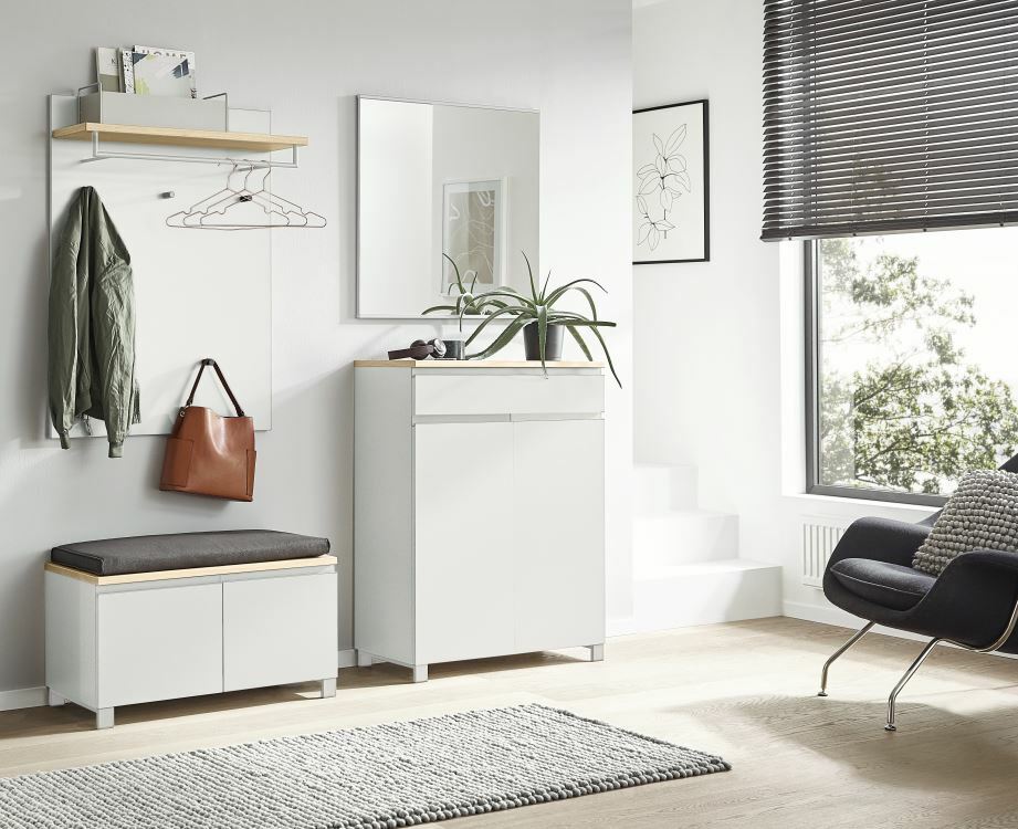 Modernes Garderoben-Set in heller, minimalistischer Einrichtung mit Spiegel, Hakenleiste, Sitzbank und Schrank, seitliche Perspektive.