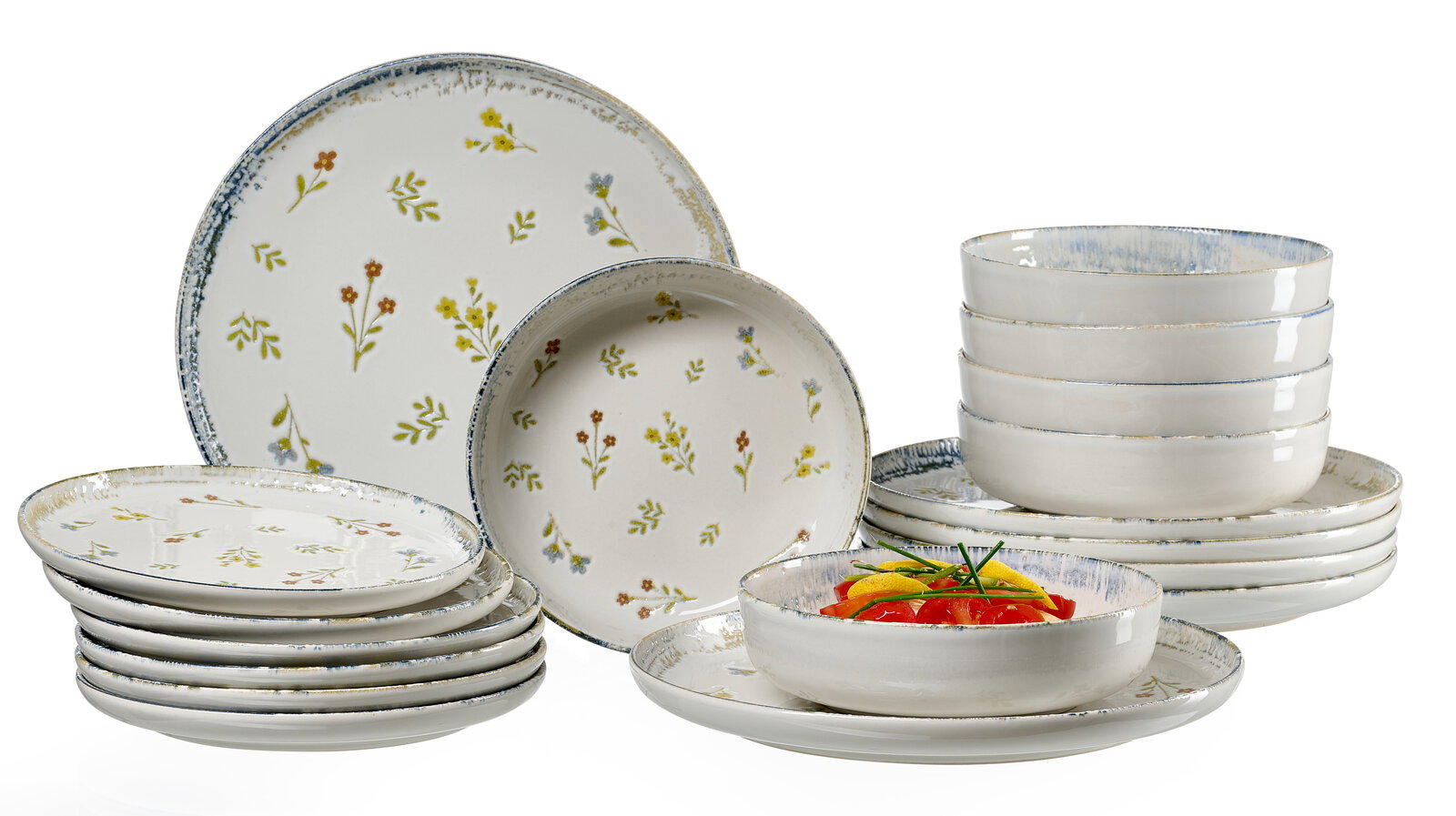 Keramik-Geschirrset in Weiß mit zartem Blumenmuster und blauem Rand, bestehend aus Tellern und Schalen, frontal in leichter Schrägansicht auf weißem Hintergrund arrangiert.