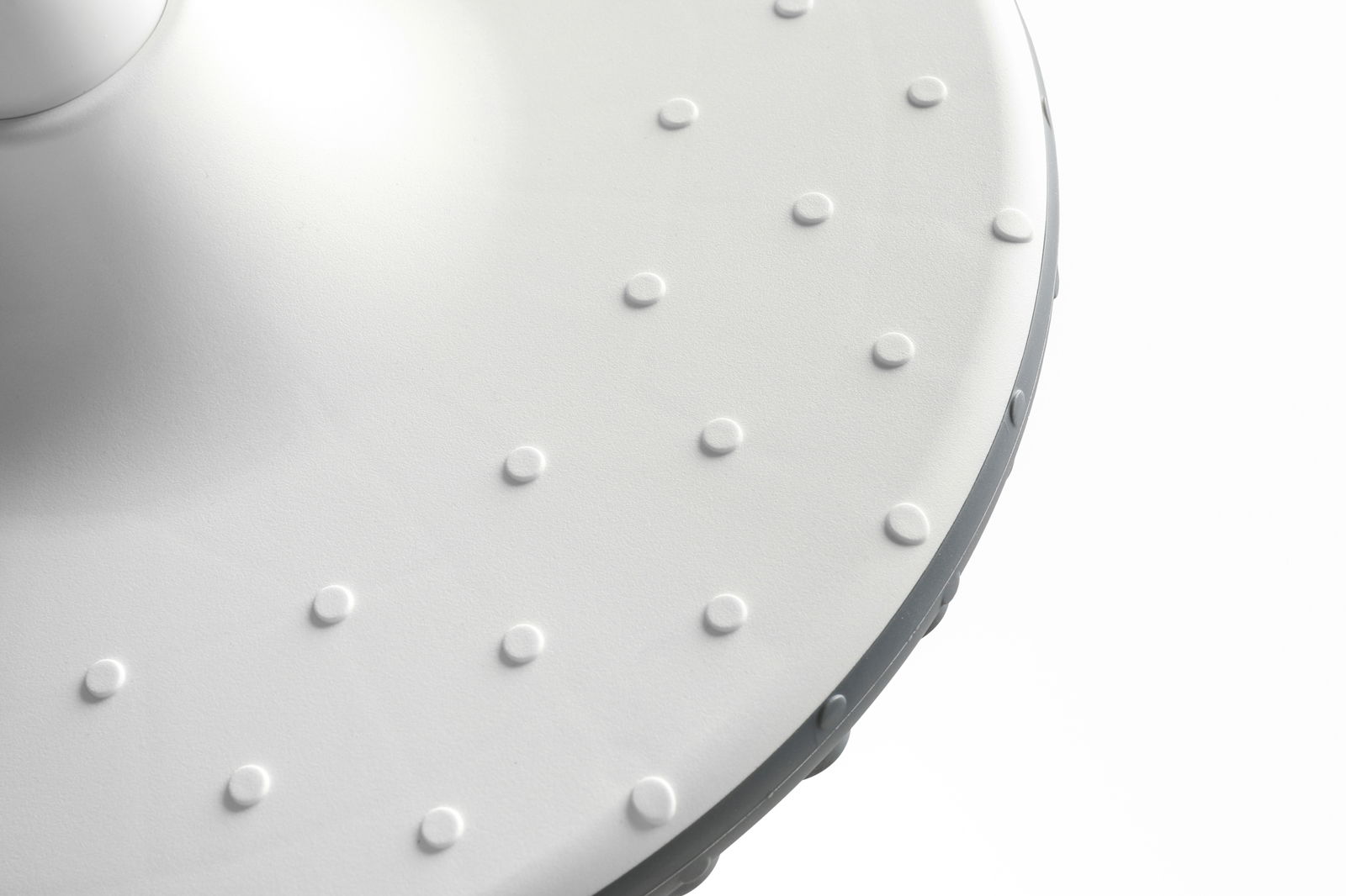 Nahaufnahme der strukturierten Oberfläche eines Schwinghockers, von oben betrachtet.