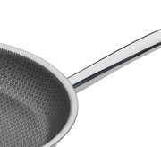 Nahaufnahme einer Bratpfanne XL CUT RESIST PURESpring mit hexagonalem Muster auf der Innenfläche und einem glänzenden Griff.