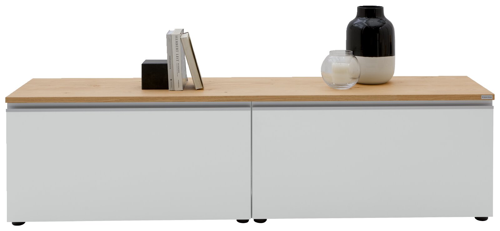 Modernes Sideboard mit weiß-grauen Fronten und heller Holzplatte, dekoriert mit Büchern und schwarzer Vase, frontal aus leicht erhöhter Perspektive aufgenommen