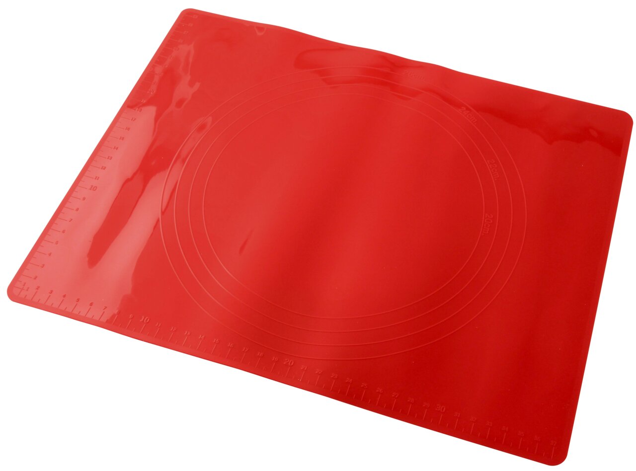 Rote Silikonmatte 38x30cm mit Maßangaben und kreisförmigen Markierungen, schräg von oben fotografiert.