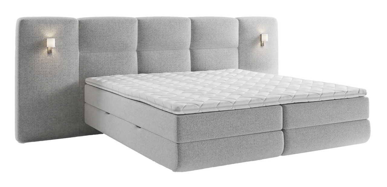 Graues Boxspringbett mit gepolstertem Kopfteil und integrierten Leuchten, seitliche Perspektive