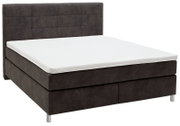 Boxspringbett in seitlicher Perspektive mit dunklem Kopfteil und weißer Matratze