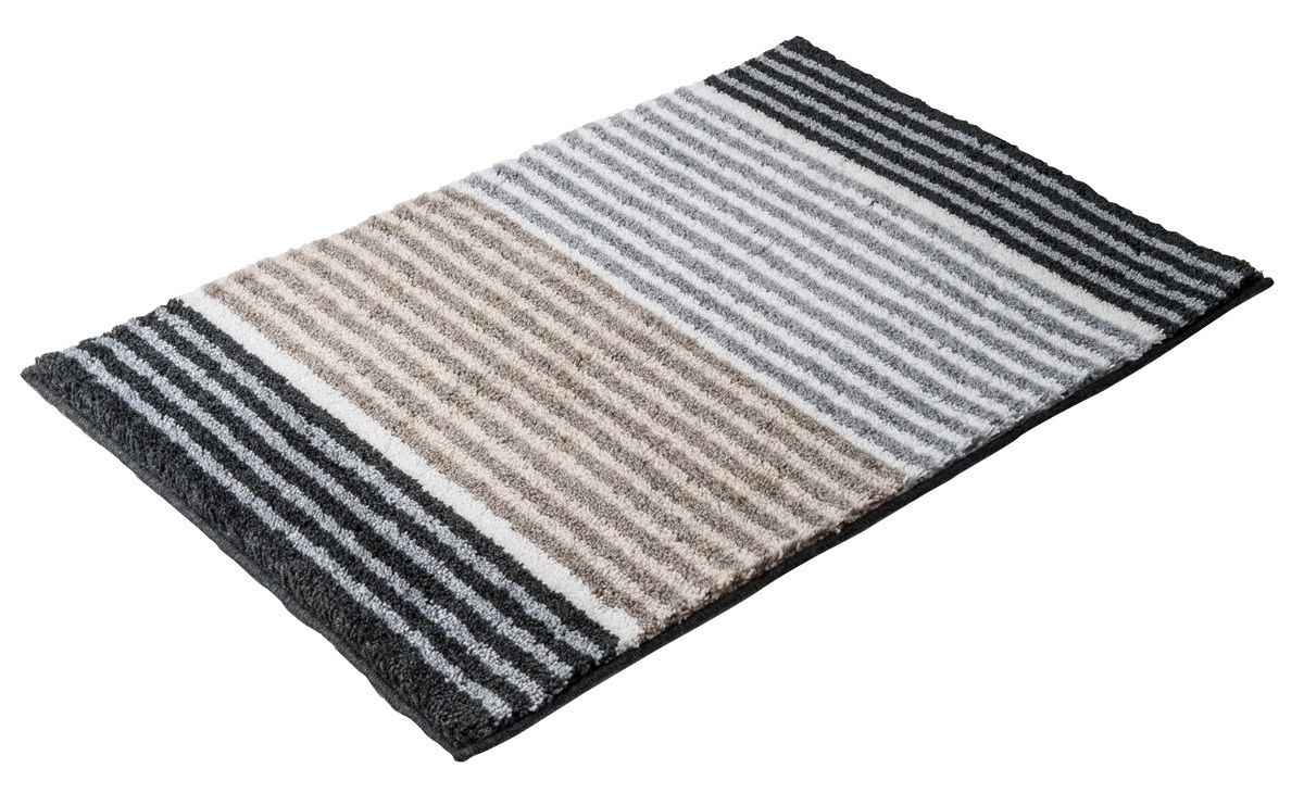Badteppich mit Streifenmuster in Grau- und Beigetönen, perspektivisch von schräg oben fotografiert.