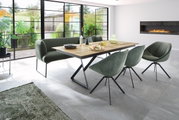 Moderne Esszimmerbank in einem hellen Raum mit großen Fenstern, neben einem Holztisch und stilvollen Stühlen, aus seitlicher Perspektive.