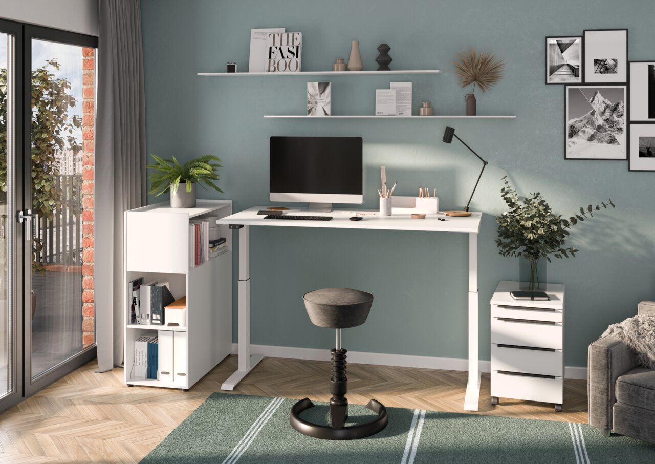 Moderner Arbeitsplatz mit höhenverstellbarem Schreibtisch, ergonomischem Hocker und Rollcontainer in einem stilvoll eingerichteten Raum, seitliche Perspektive.