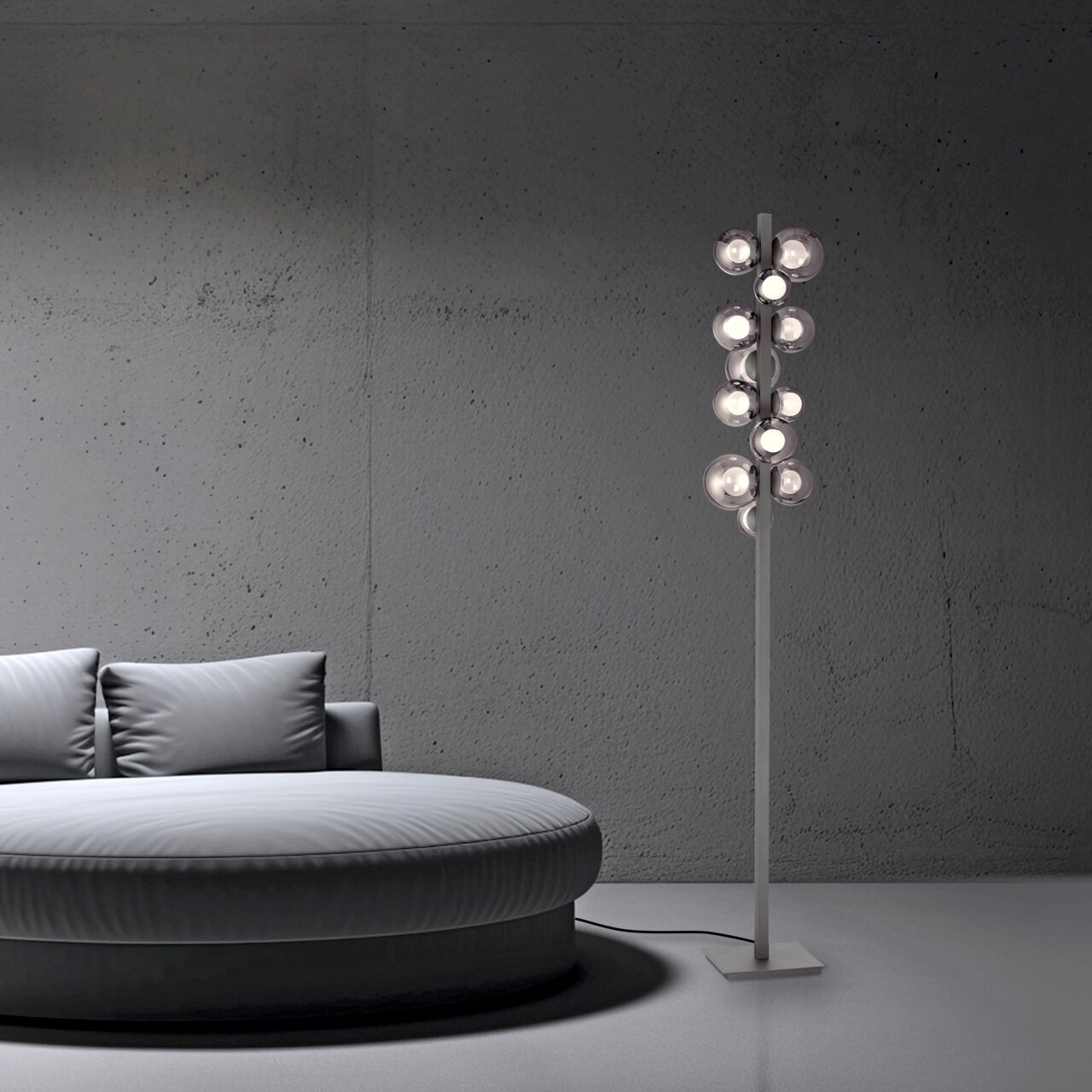 Moderne LED-Stehleuchte PURE POPOUT mit mehreren kugelförmigen Leuchten, seitliche Perspektive neben einem runden Sofa in einem minimalistischen Raum.