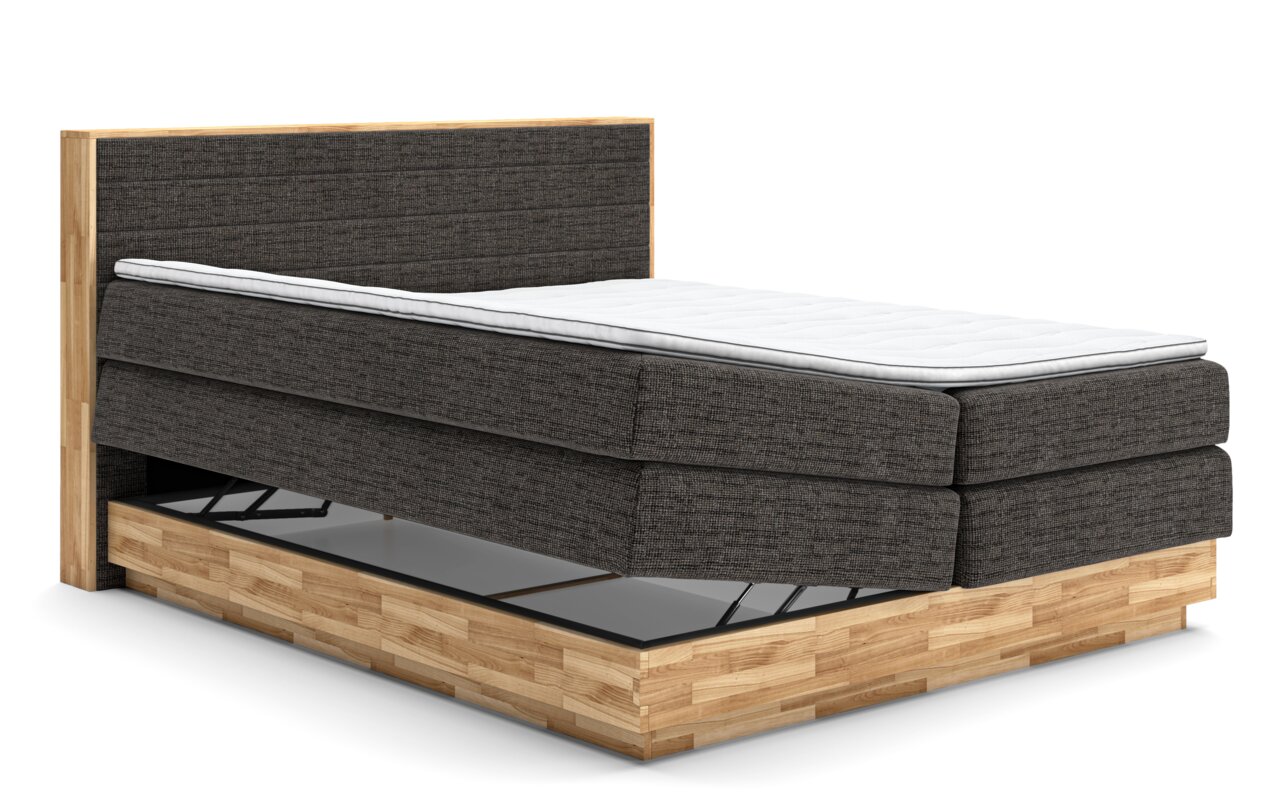 Boxspringbed met grijze stoffen bekleding en houten frame, zijaanzicht