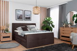 Modernes Boxspringbett in einem stilvoll eingerichteten Schlafzimmer, seitliche Perspektive.
