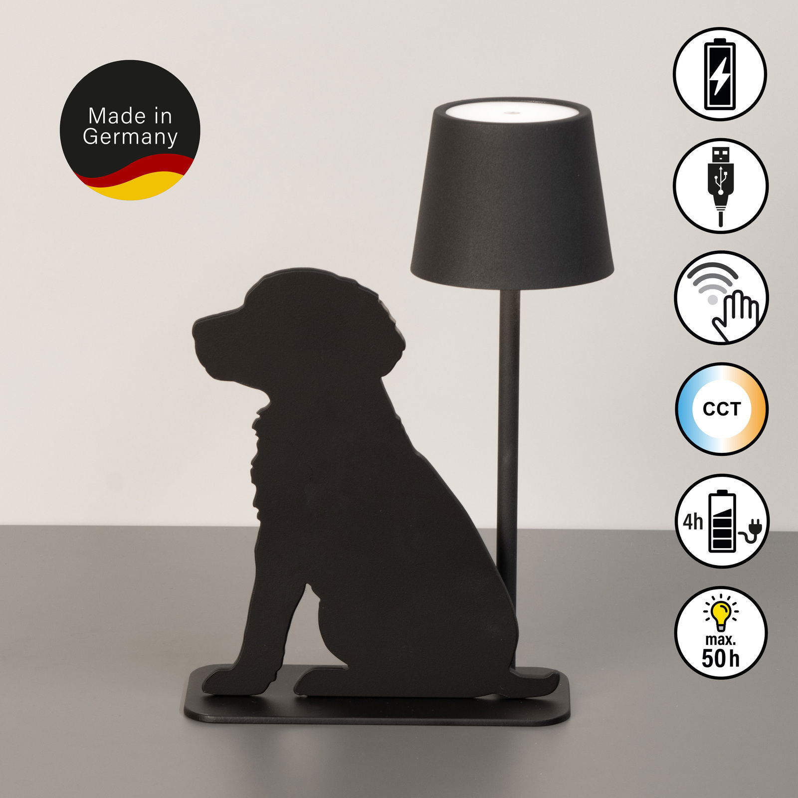 Akku-Tischleuchte mit schwarzer Silhouette eines sitzenden Hundes, seitliche Perspektive. Made in Germany, USB-Anschluss, Touch-Bedienung, CCT-Funktion, 4 Stunden Ladezeit, bis zu 50 Stunden Leuchtdauer.