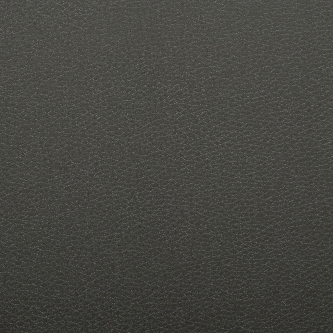 Nahaufnahme in Draufsicht: dunkelgraue, fein genarbte Leder- oder Kunstlederoberfläche mit gleichmäßigem Strukturmuster
