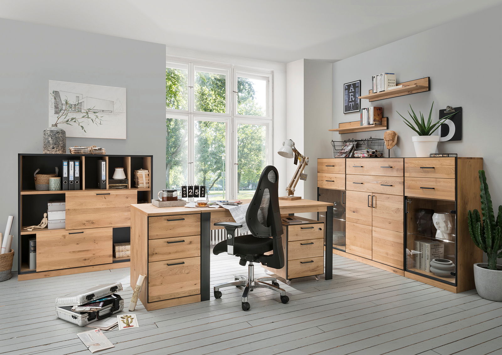 Linea Natura Schreibtisch 160 ADMIRAL Moderner Schreibtisch aus Holz mit Schubladen, umgeben von Regalen und Schränken in einem hellen Büro mit Blick auf ein großes Fenster.